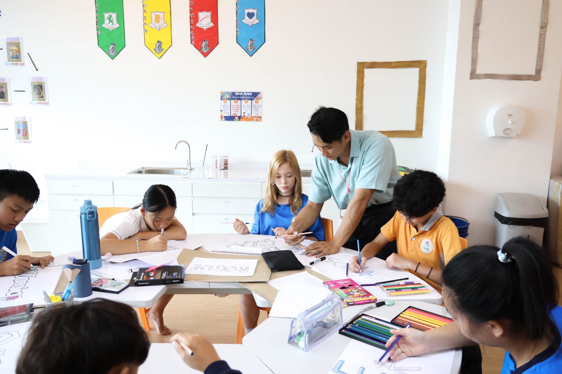 Students working on an art project with their teacher at BCIS