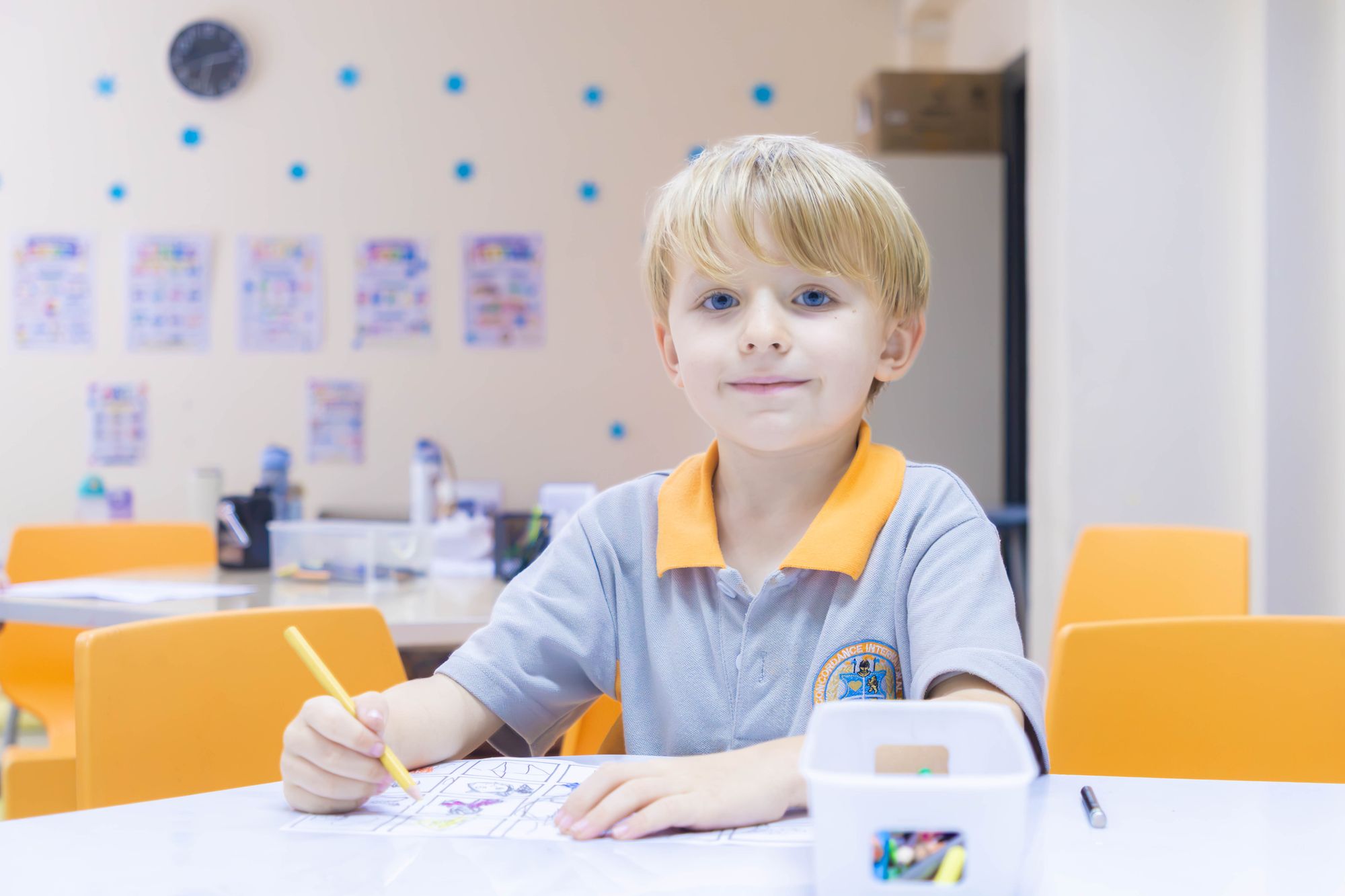 A pupil colouring at their table in the BCIS kindergarten classroom in Chiang Mai