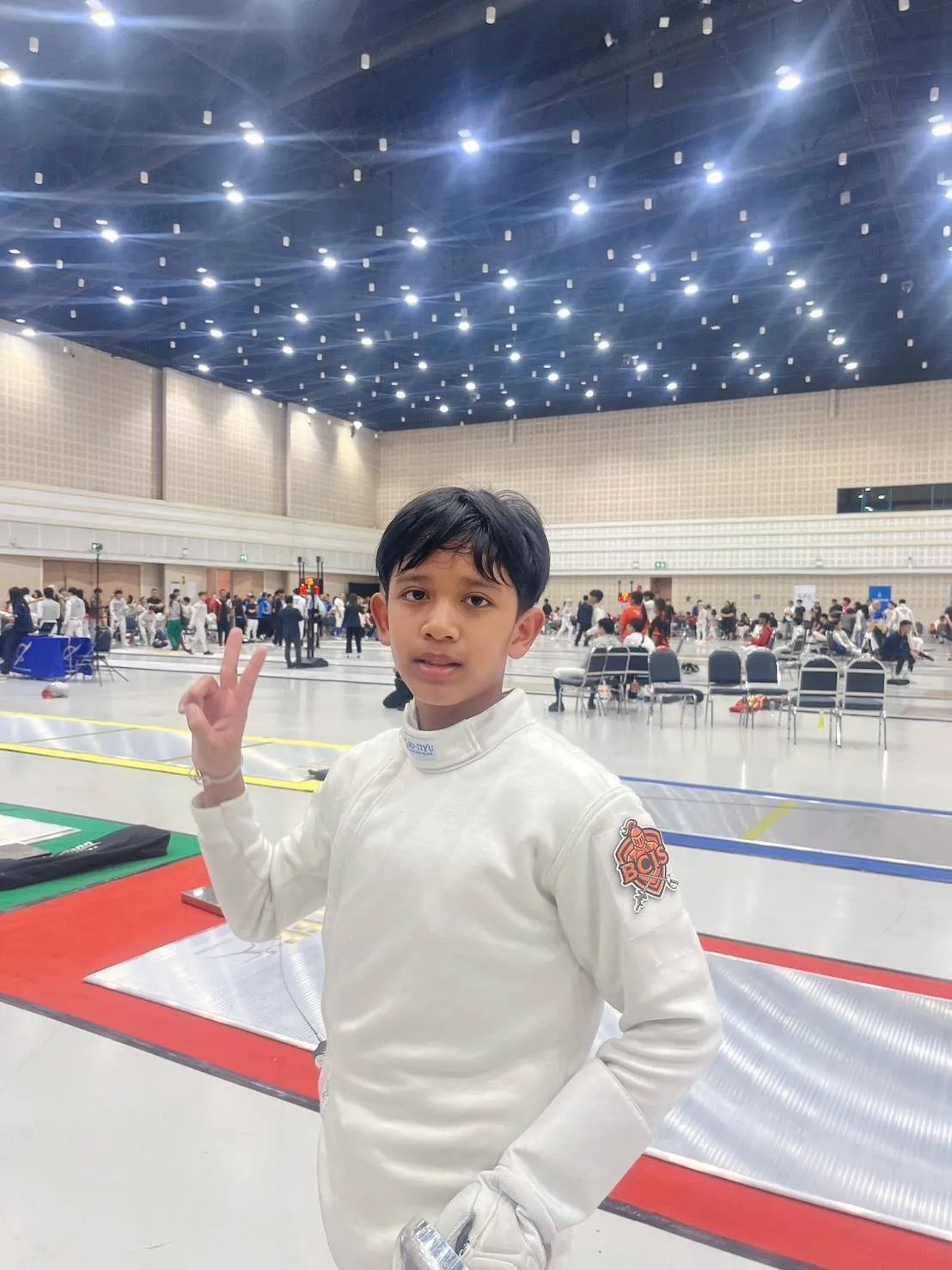 Pluem in his fencing whites at the Chiang Mai Fencing Open 2026