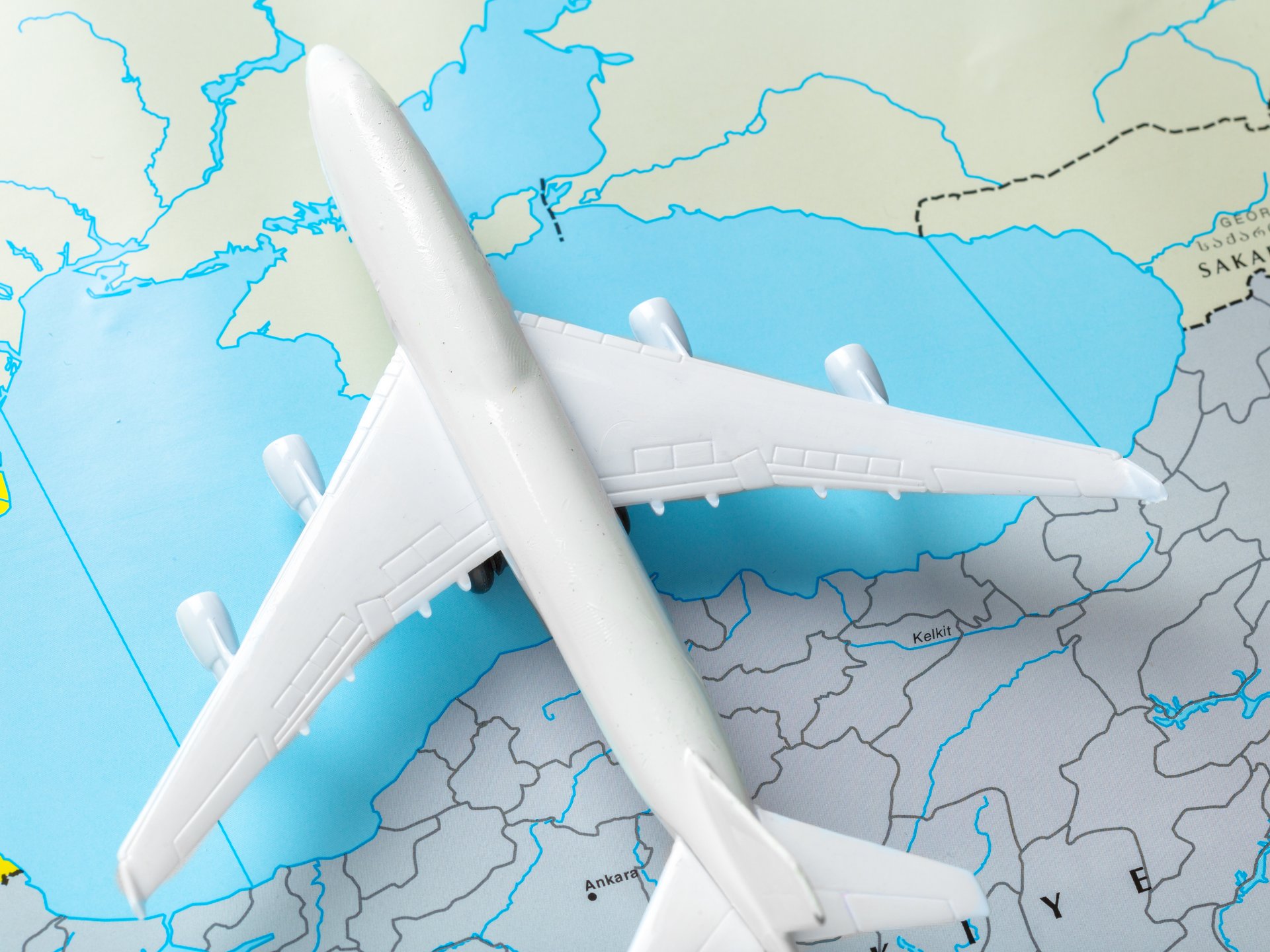 A toy aeroplane on a world map, symbolising international relocation to BCIS