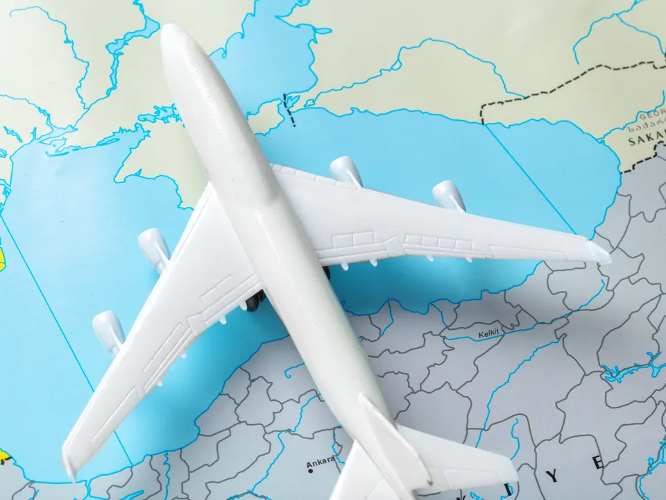 A toy aeroplane on a world map, symbolising international relocation to BCIS