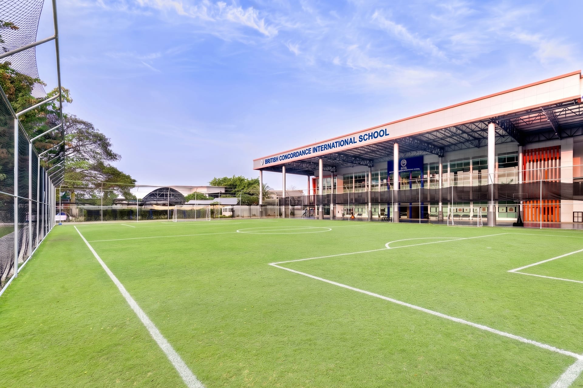 BCIS full-size grass football pitch with the main school building behind