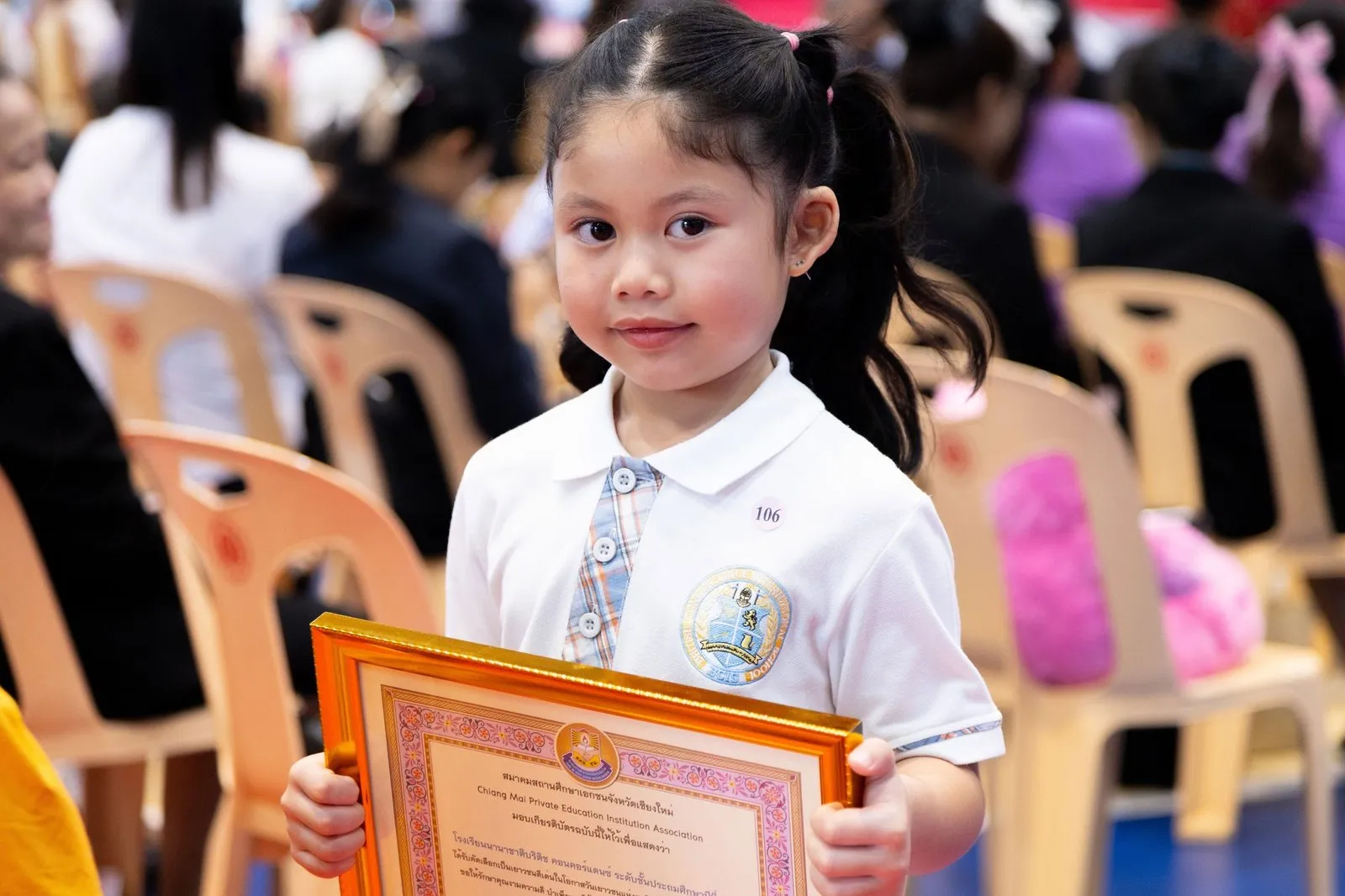 A BCIS award recipient holding a framed certificate at the ceremony
