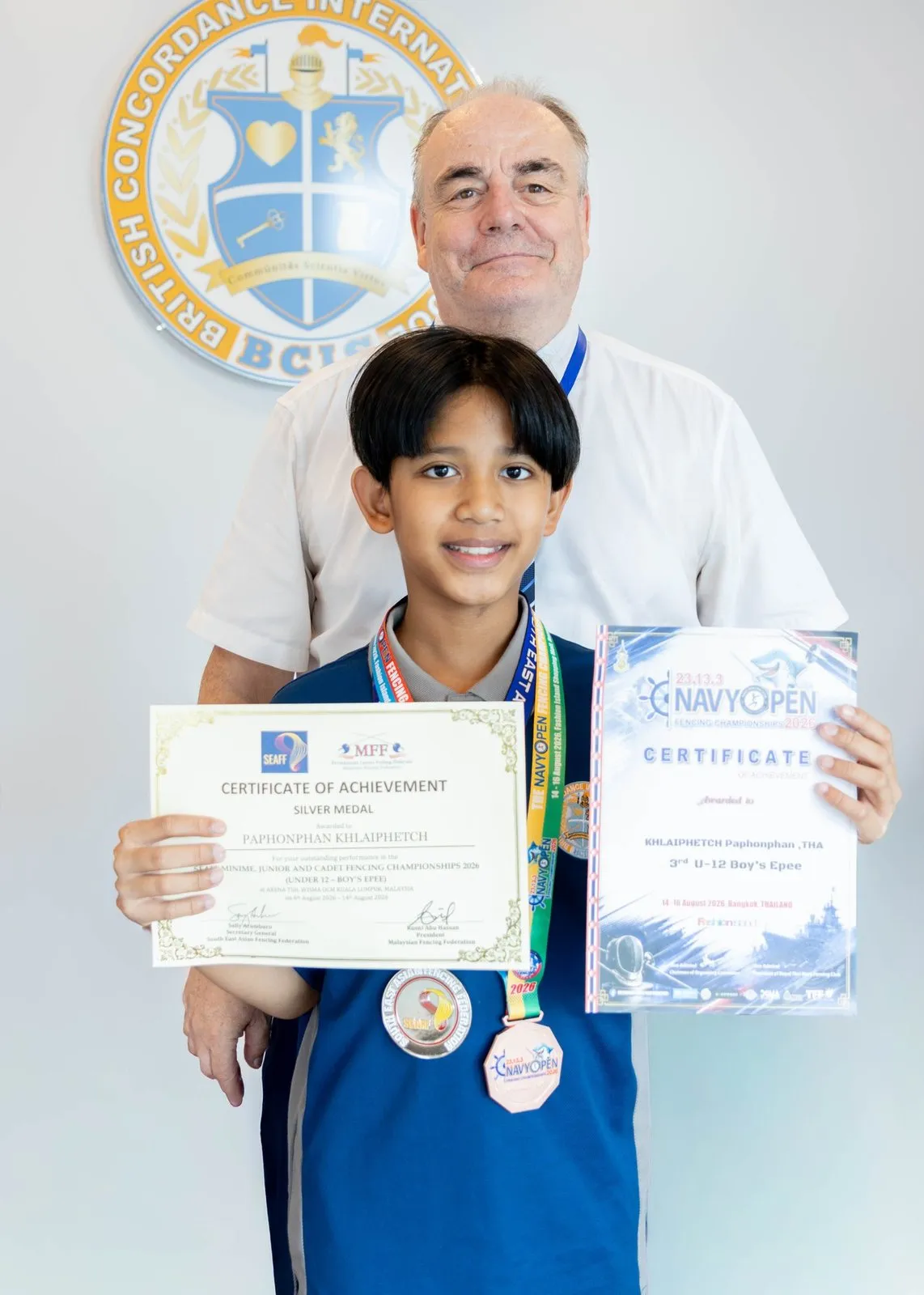 Pluem with the Head of School and his certificates at BCIS