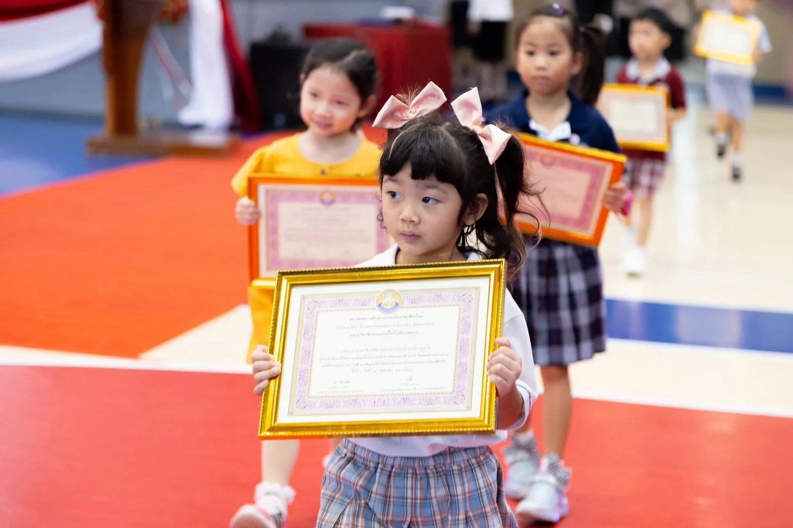 A BCIS award recipient holding a framed certificate at the ceremony