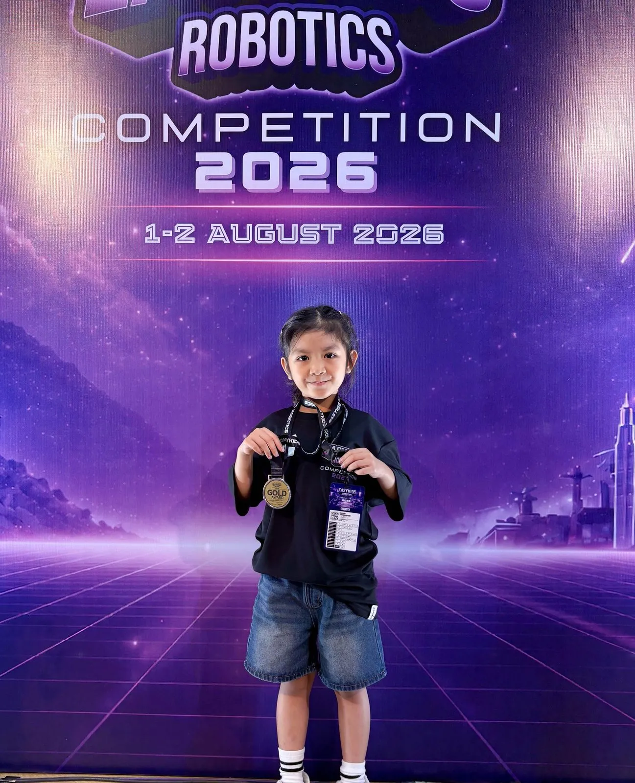 Tubtim with her gold medal in front of the competition backdrop