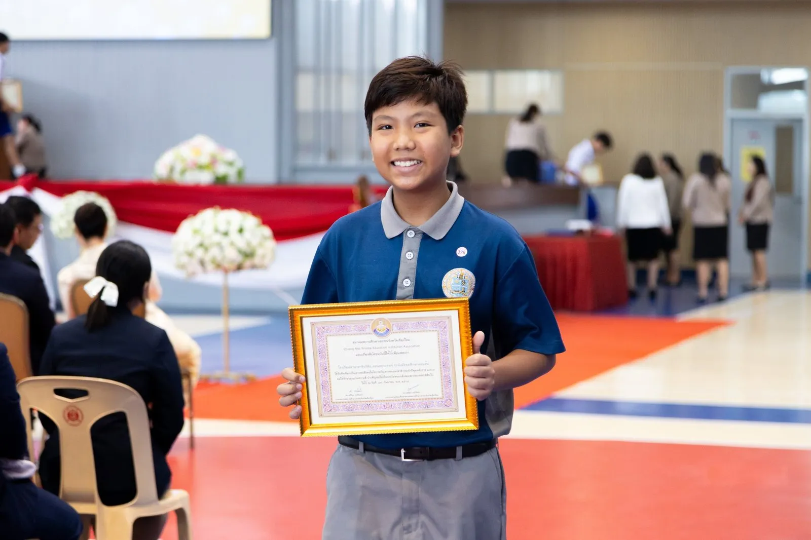 A BCIS award recipient holding a framed certificate at the ceremony