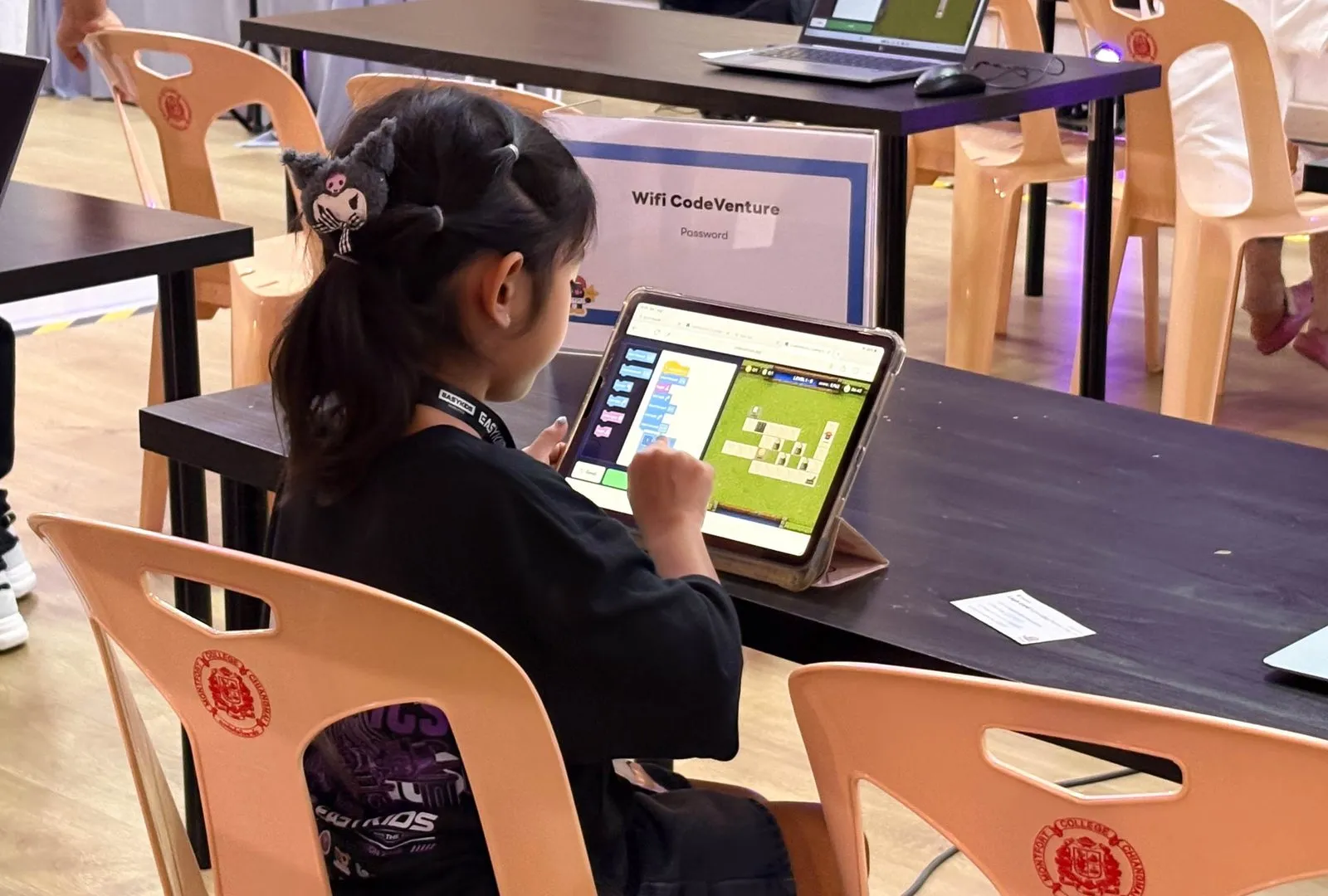 Tubtim coding on a tablet at the competition