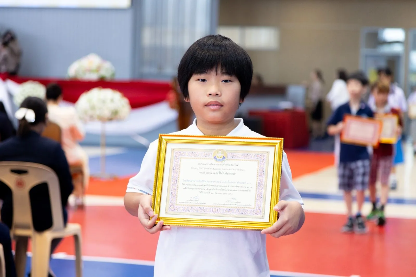 A BCIS award recipient holding a framed certificate at the ceremony