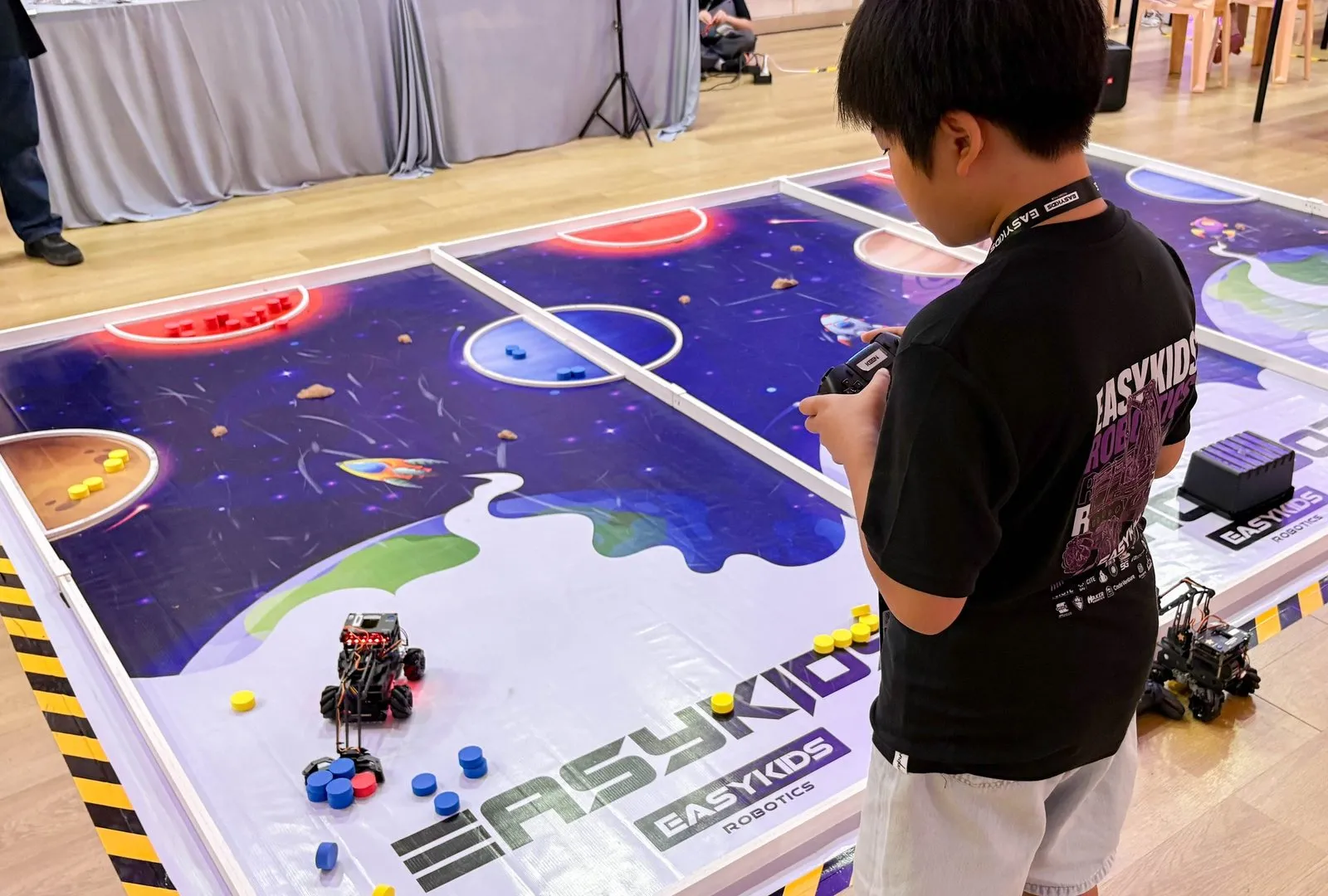 Keen guiding his robot around the competition mat