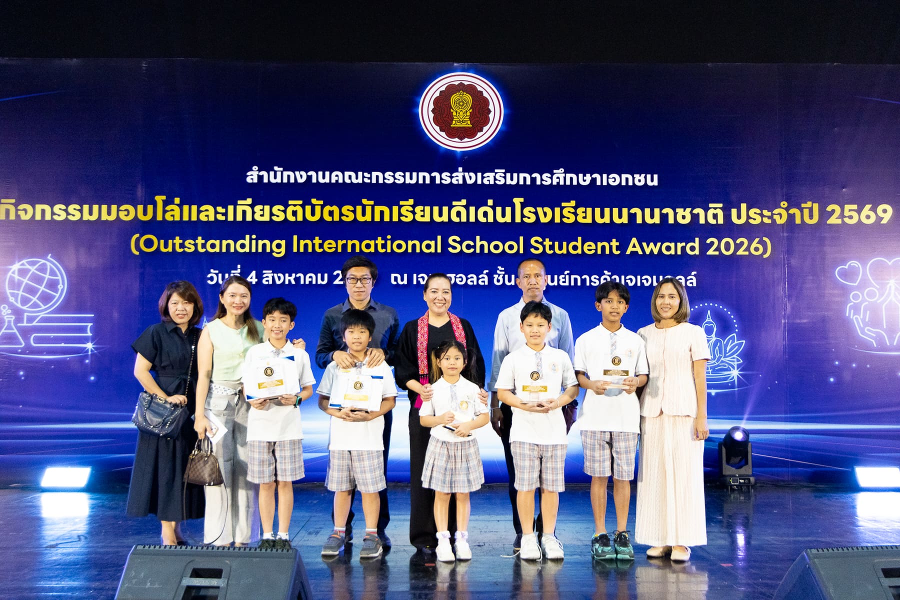 BCIS staff and award recipients on stage in front of the Outstanding International School Student Award 2026 banner