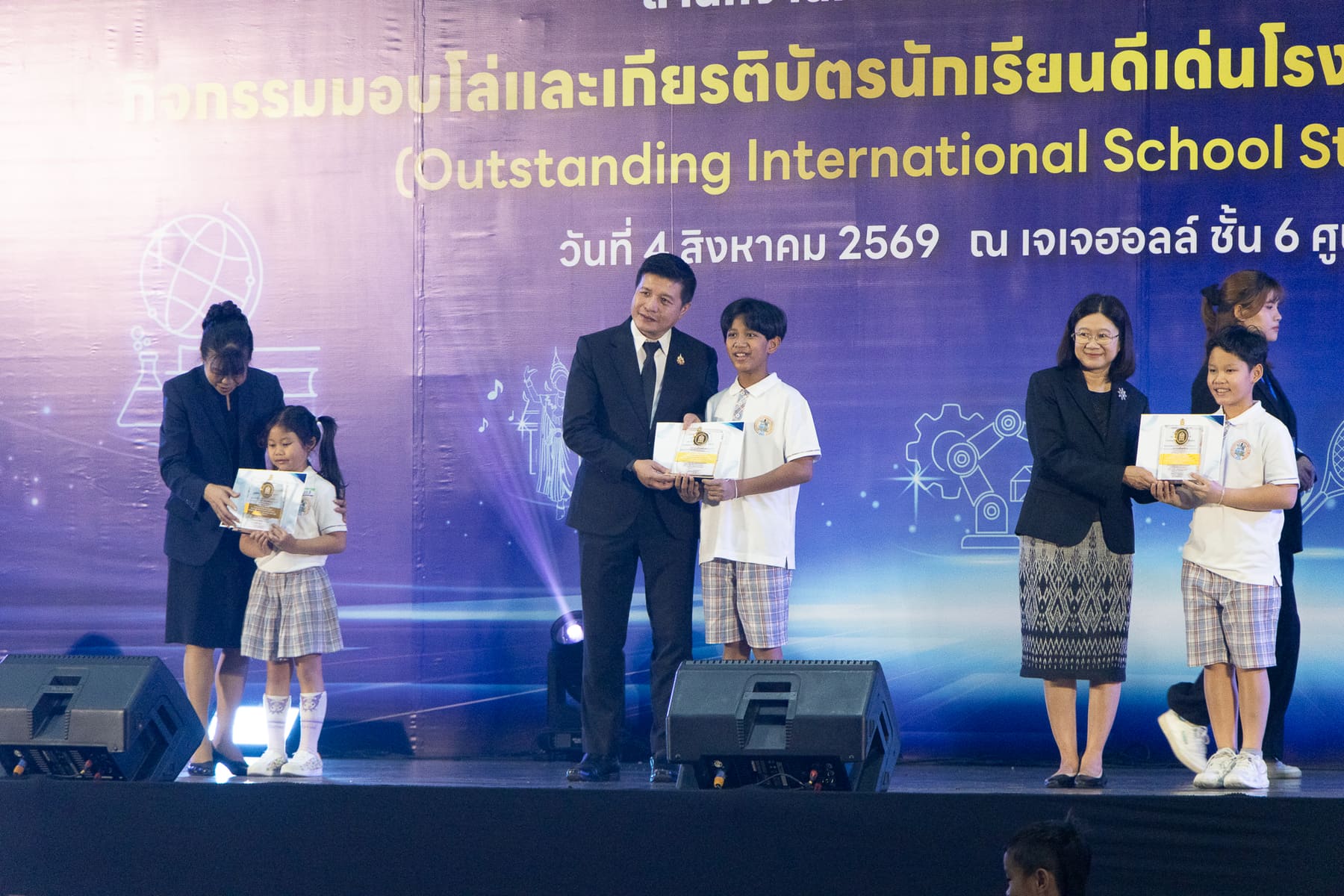 A BCIS student shaking hands and receiving his certificate on stage