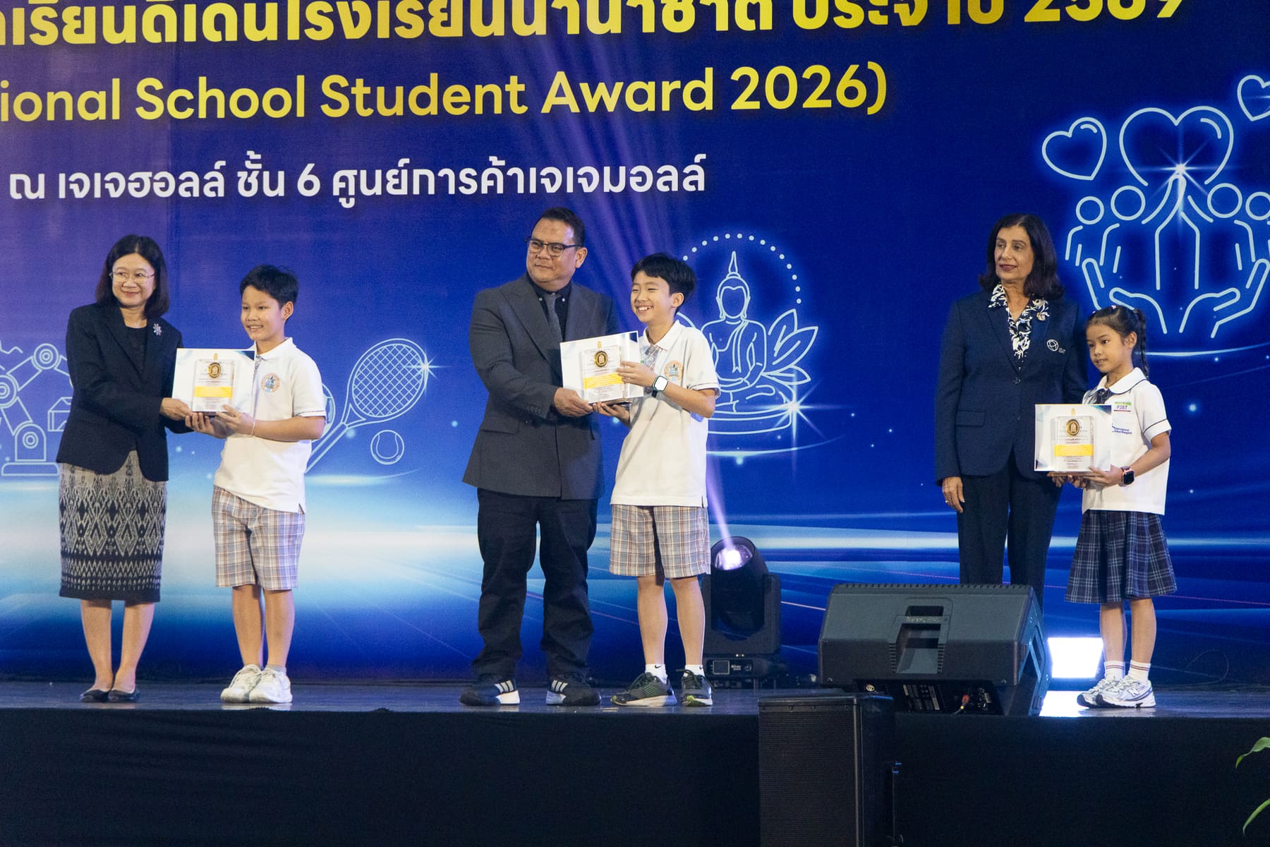 A BCIS student receiving his Sports and Recreation award on stage