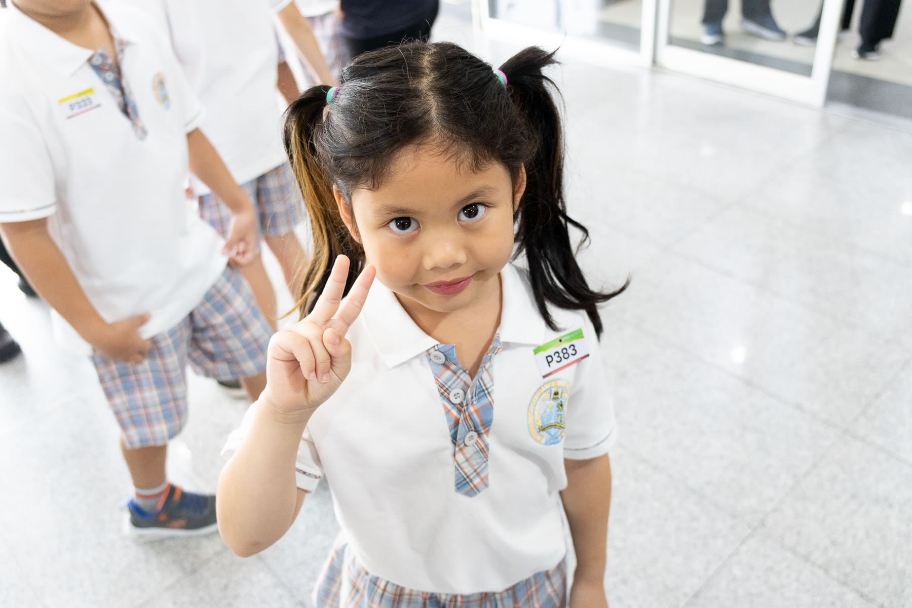 A young BCIS award recipient smiling for the camera before the ceremony