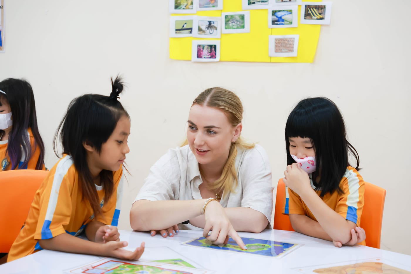 Teacher guiding Primary students through a reading lesson at BCIS