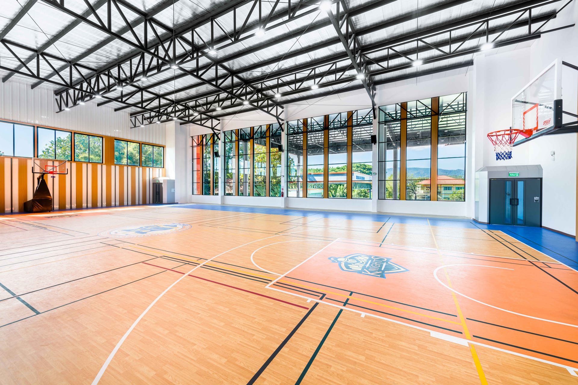 BCIS indoor sports hall with basketball court and badminton nets
