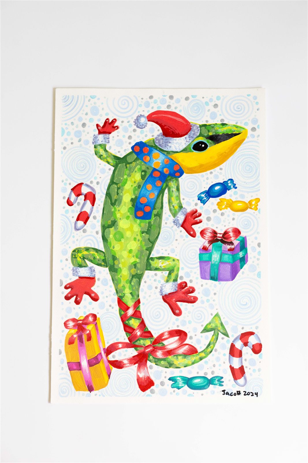 Student painting of a festive gecko with gifts and candy