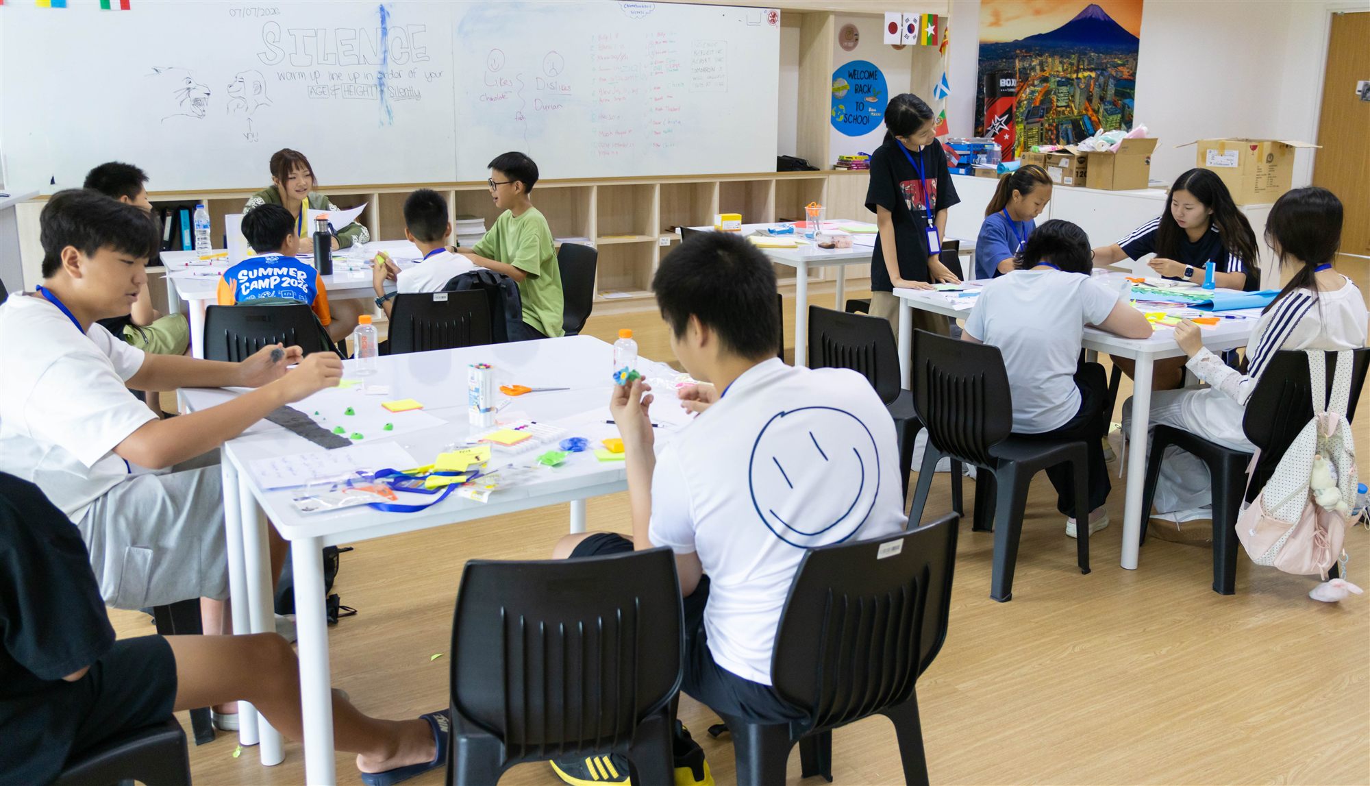 A wide view of campers working together at their desks in the classroom