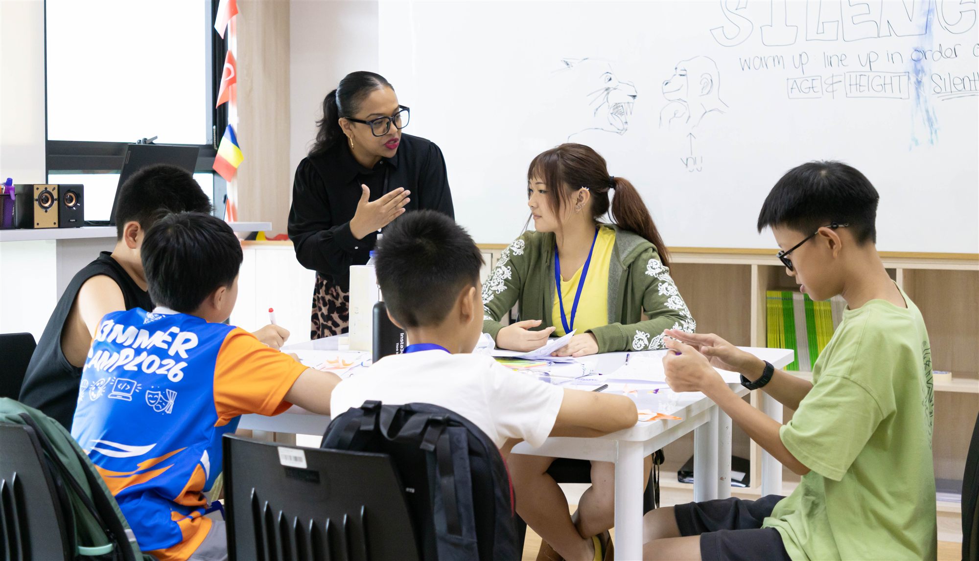 A teacher talking through the activity with a small group