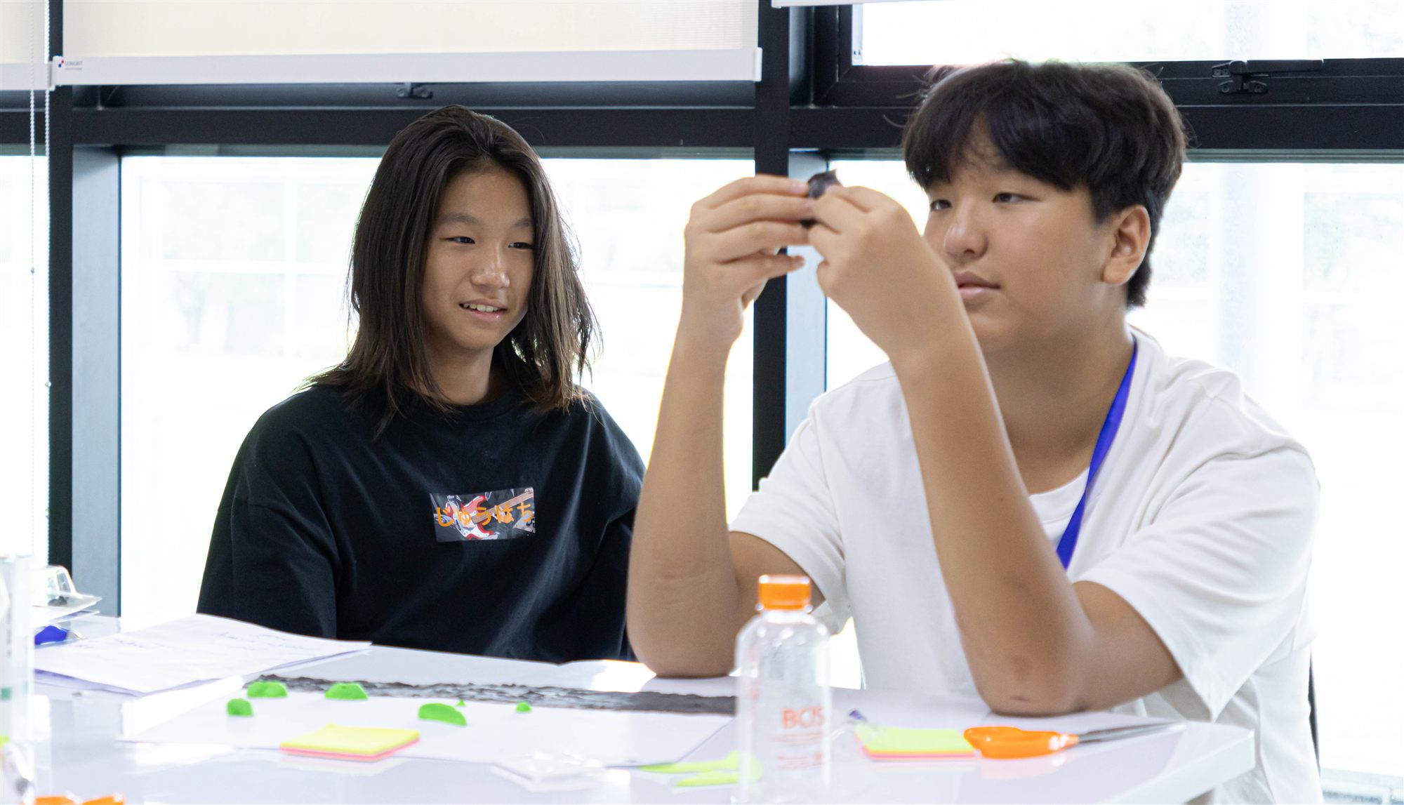 Two campers working together with modelling clay