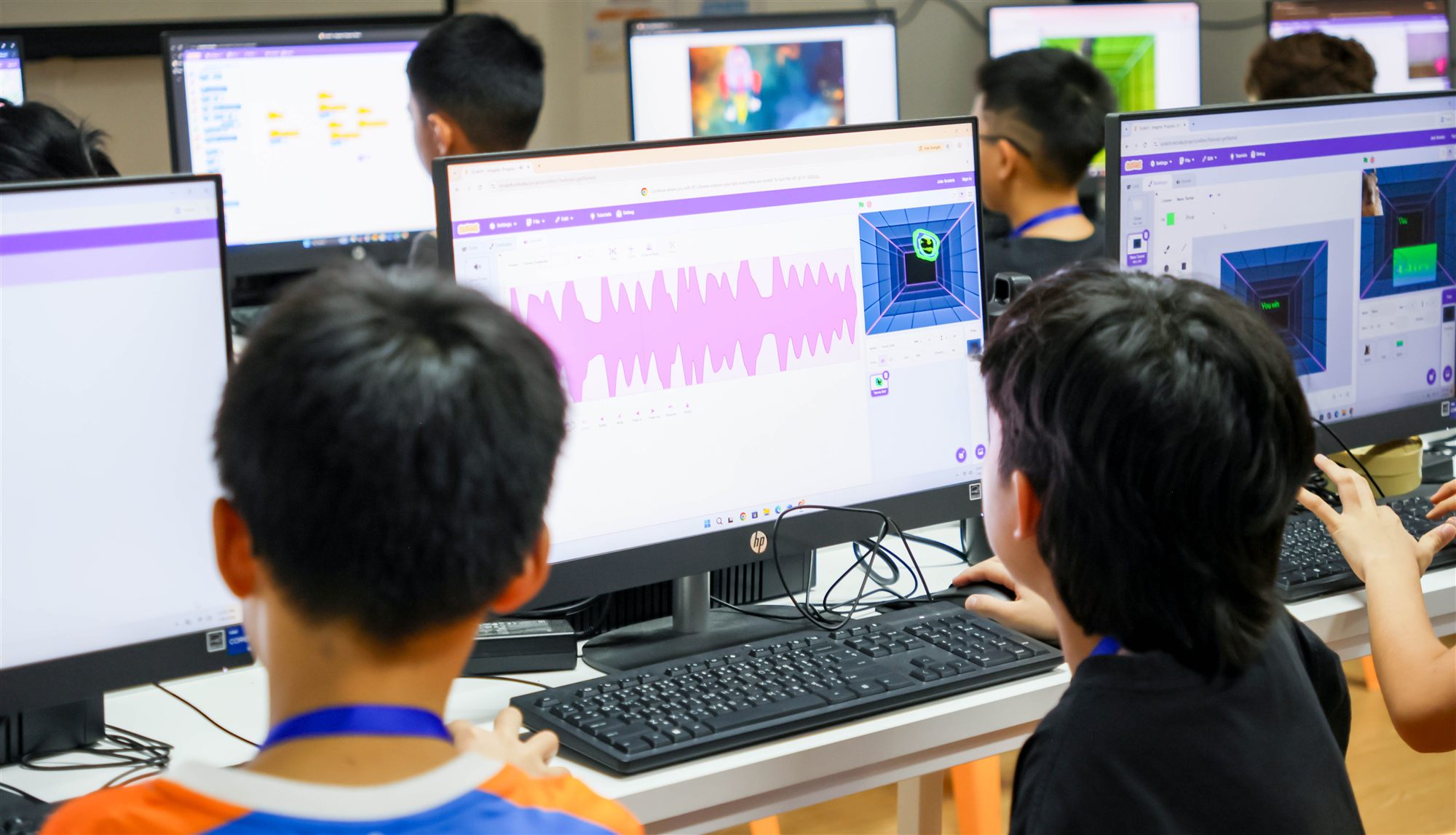 A camper's Scratch coding project, with sound waves and a 3D game on screen