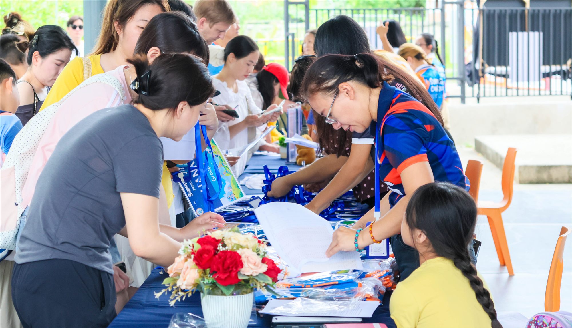 Families at the BCIS Summer Camp registration desk