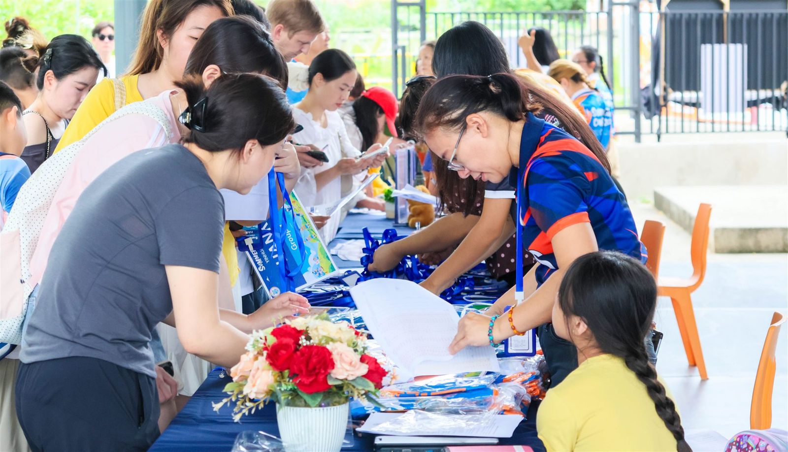 Families at the BCIS Summer Camp registration desk